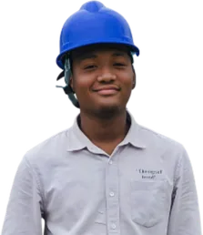 Man in a blue hard hat and gray shirt smiling.