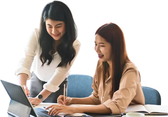 Two women reviewing a laptop together.