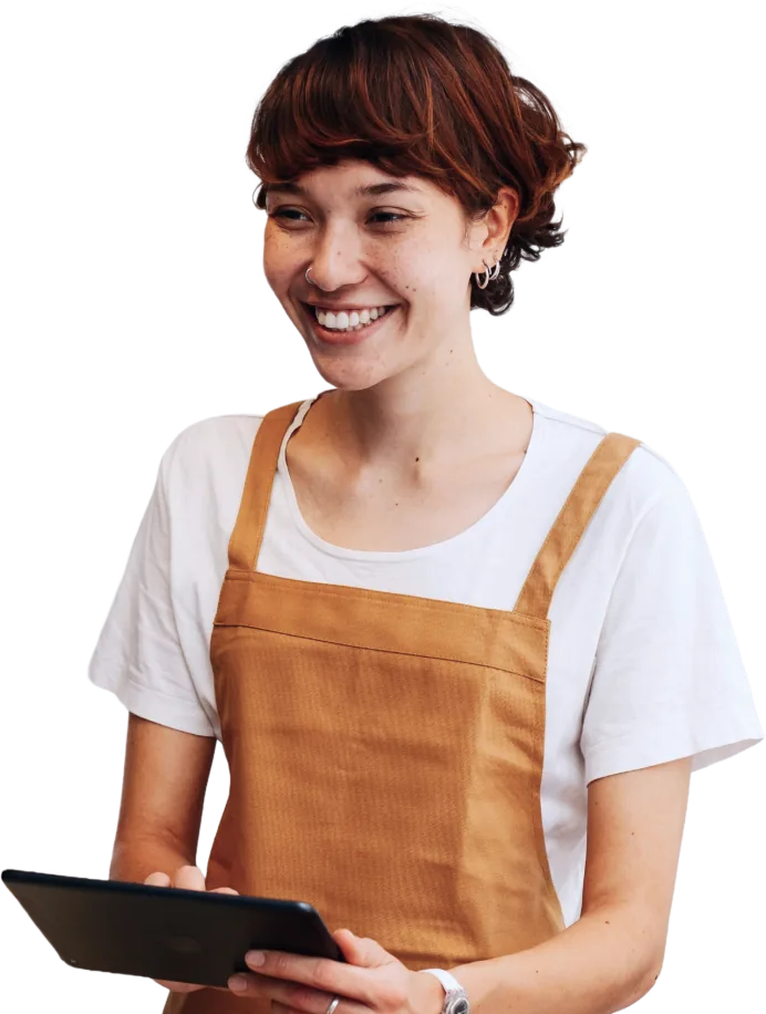 Woman in an apron holding a tablet.